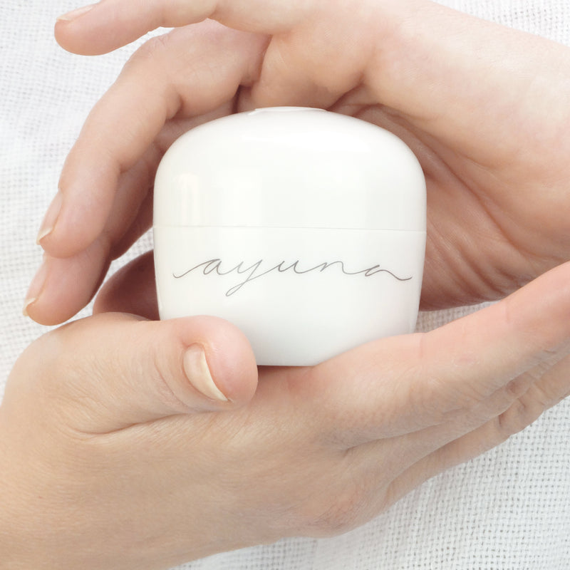 Hands holding Ayuna Cream